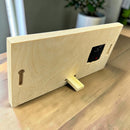 Back view of a Red Bird Gift Company minimalist rectangular wooden tabletop clock with a built-in stand and wall mount.